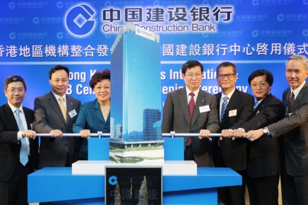 At the opening of the CCB Centre are (from left) Arthur Yuen Kwok-hang, deputy chief executive of the Hong Kong Monetary Authority; Zhao Huan, vice-president of CCB; Yin Xiaojing, vice-director of the central government's liaison office; Wang Hongzhang, chairman of CCB; Paul Chan, Secretary for Development; Pang Xiusheng, vice-president of CCB; and Robert Ng Chee Siong, chairman of Sino Land. Photo: Paul Yeung
