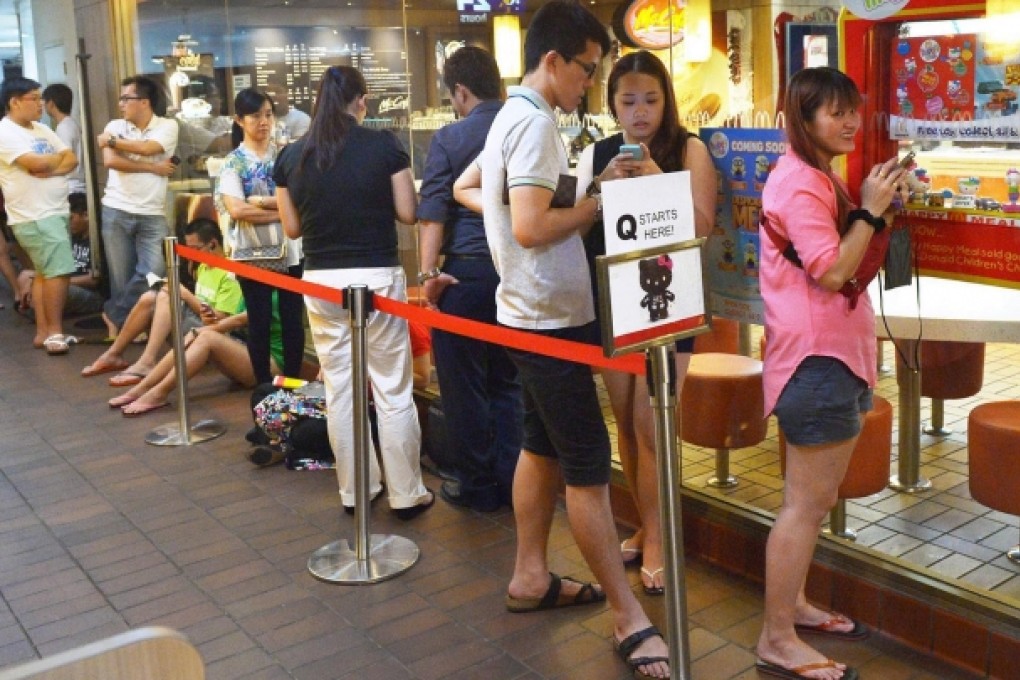 A queue outside a Singapore McDonald's yesterday. Photo: AFP
