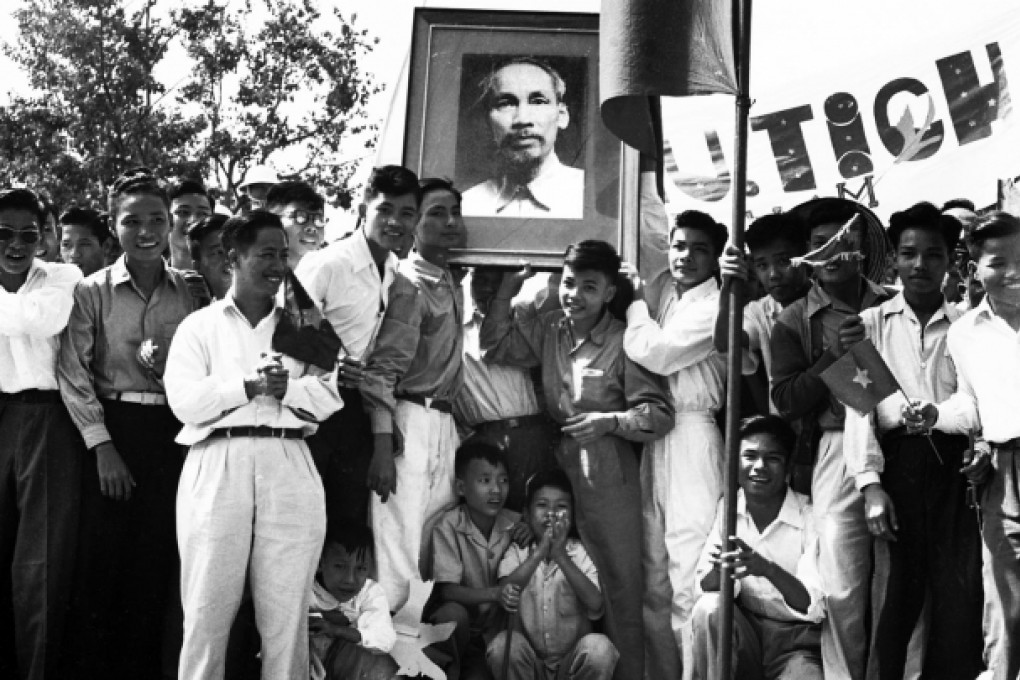 Supporters of Ho Chi Minh bear a portrait of the communist leader in Vietnam in 1960. Photos: Corbis; AFP