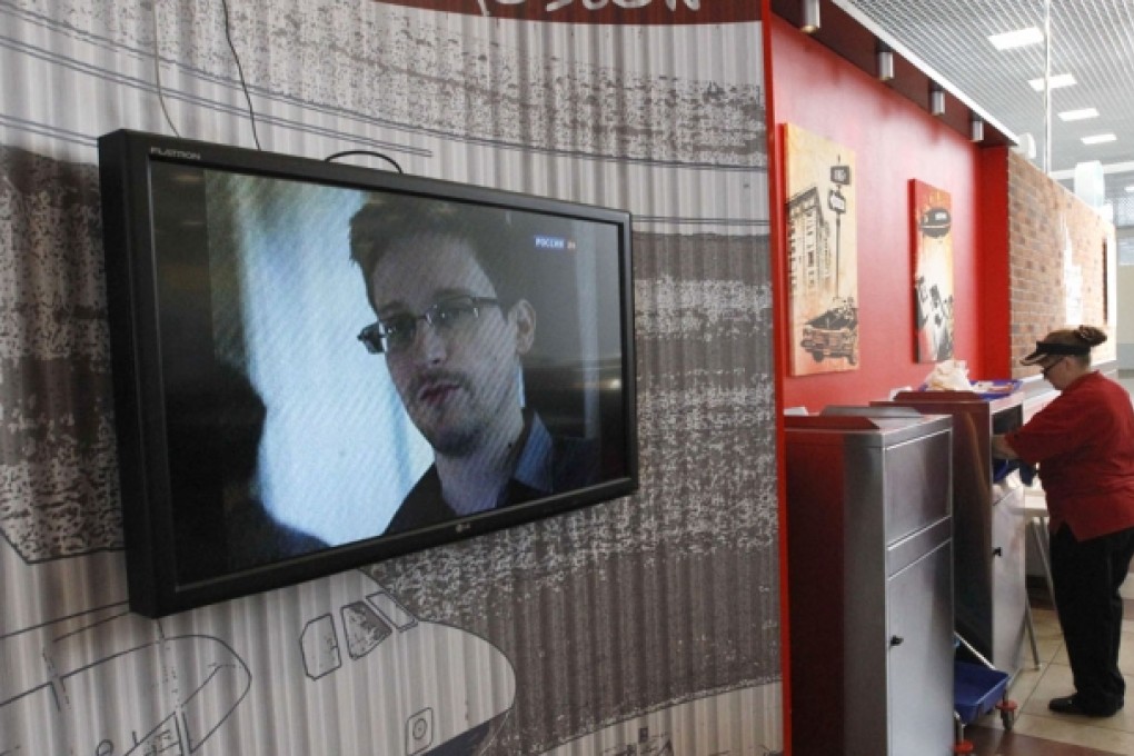 A television screens the image of former US spy agency contractor Edward Snowden during a news bulletin at a cafe at Moscow's Sheremetyevo airport. Photo: Reuters