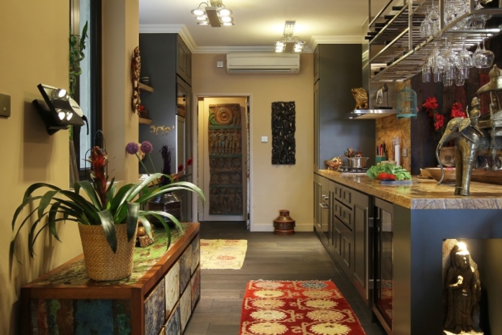 Kitchen: The cabinetry and countertops in the kitchen and the stainless-steel glass rack were custom made by Loft Square Interior Design (4/F, Block A, Alexandra Industrial Building, 1064 Tung Chau West Street, Lai Chi Kok, tel: 9497 9125). The chest, made from recycled boat wood, and the rugs, were all bought from Shambala (2/F, Horizon Plaza, 2 Lee Wing Street, Ap Lei Chau, tel: 2555 2997). Protruding from the wall is the control panel for a Bang & Olufsen sound system.