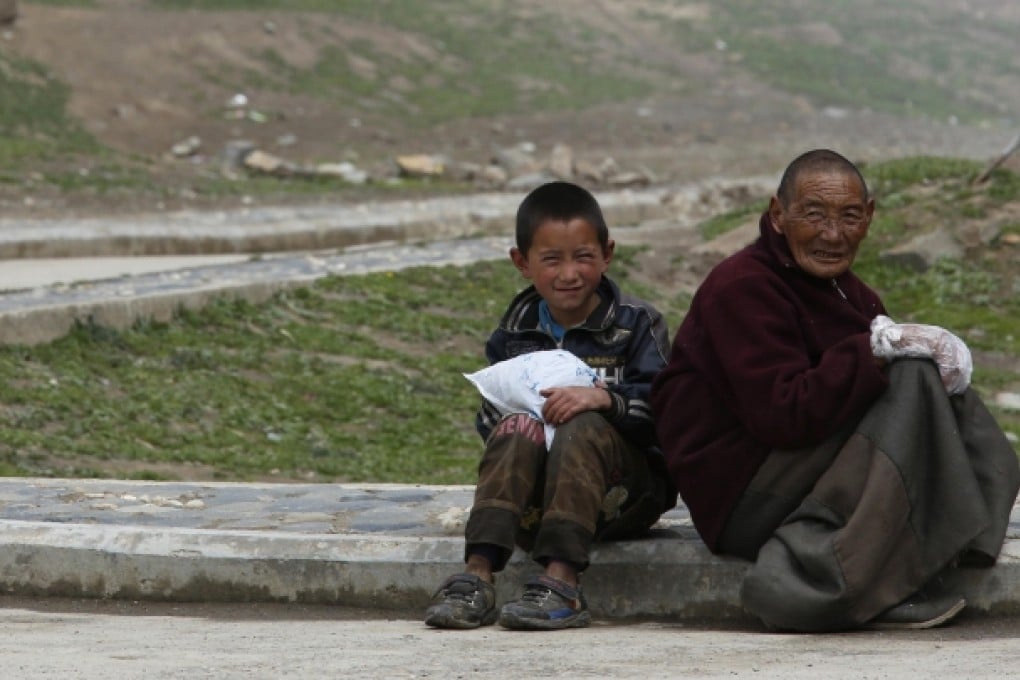 A Tibetan boy and man in Barma township, China. Photo: Reuters