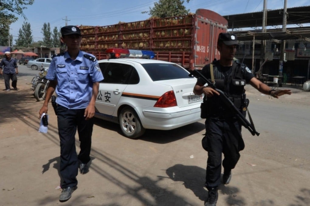 Police patrol the road into the town of Lukqun. Photo: AFP