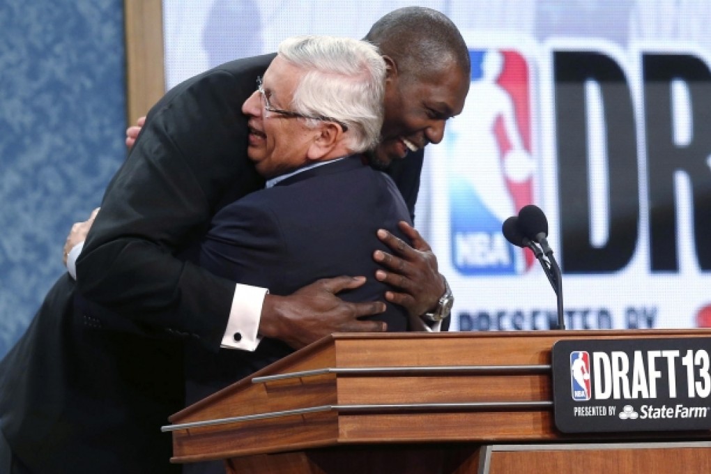Retired star Hakeem Olajuwon hugs David Stern. Photo: AP