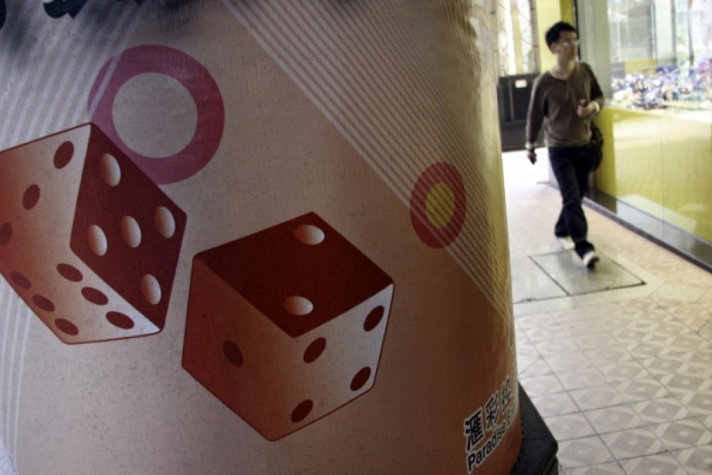 A pedestrian walks by an ad for a casino in Macau, where a Nevada gaming official says money laundering is rife. Photo: Bloomberg