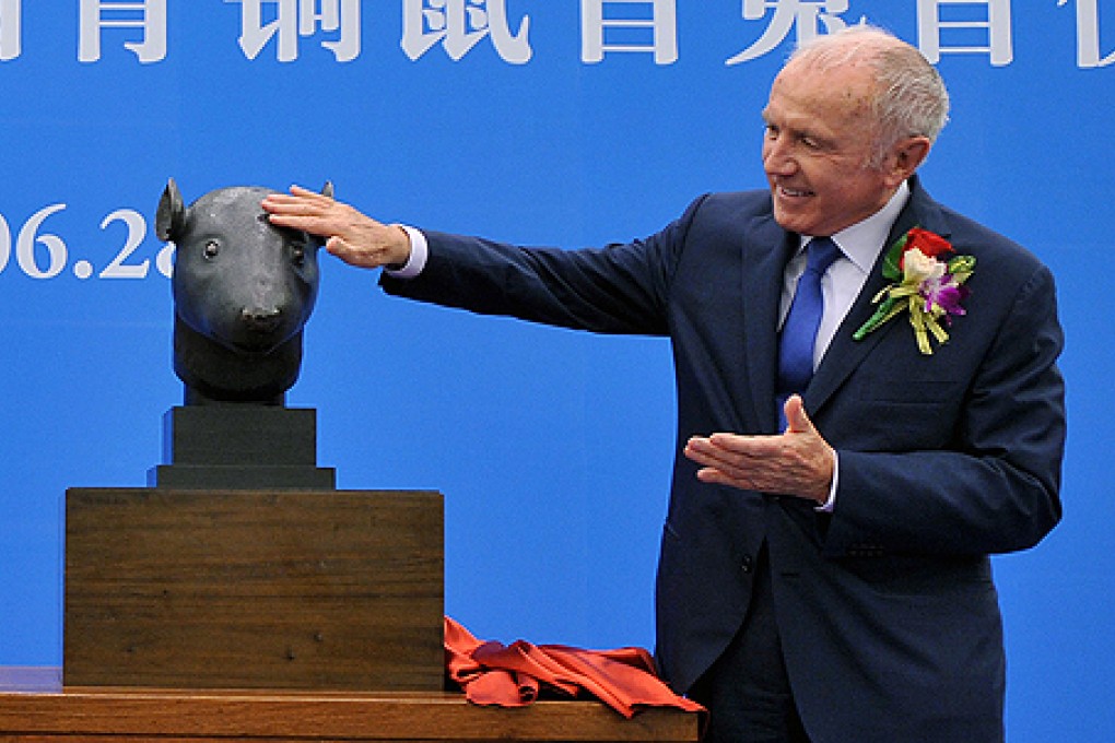 French billionaire Francois Pinault hands the bronzes, one of a rabbit and one of a rat, back to China. Photo: Xinhua