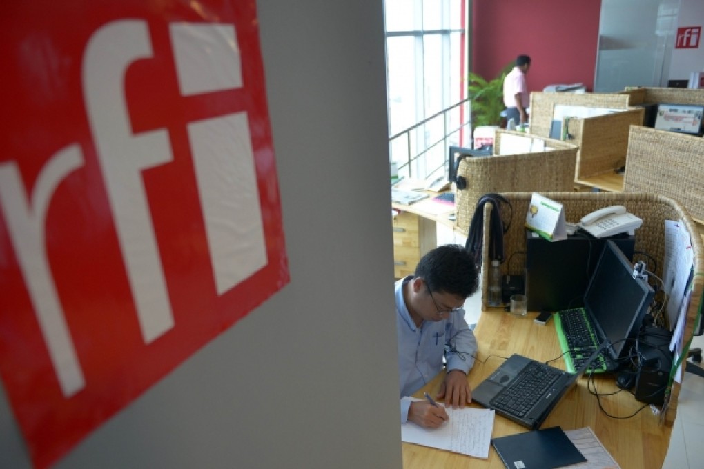 A Cambodian staff of Radio France Internationale (RFI) in Khmer Service, works during the Inauguration of Radio France Internationale (RFI) in Khmer Service station in Phnom Penh. Photo: AFP