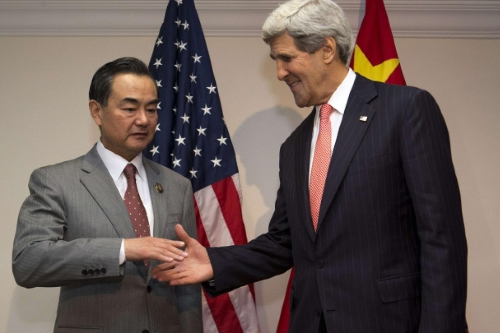 Foreign Minister Wang Yi shakes hands frostily with US Secretary of State John Kerry at the Asean meeting in Bandar Seri Begawan, Brunei. Photo: Reuters