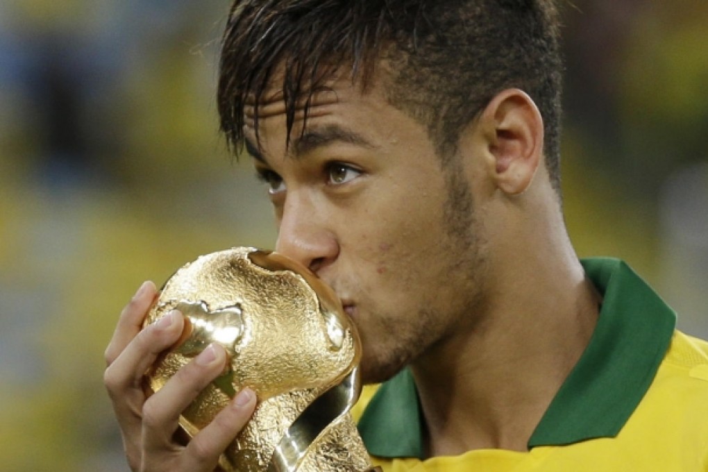 Neymar kisses the Confederations Cup trophy.