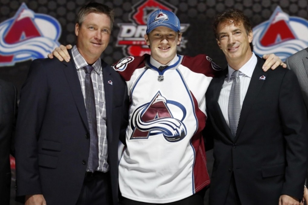 Nathan MacKinnon (centre) with Colorado Avalanche president Josh Kroenke (left) and team general manager Joe Sakic. Photo: Reuters