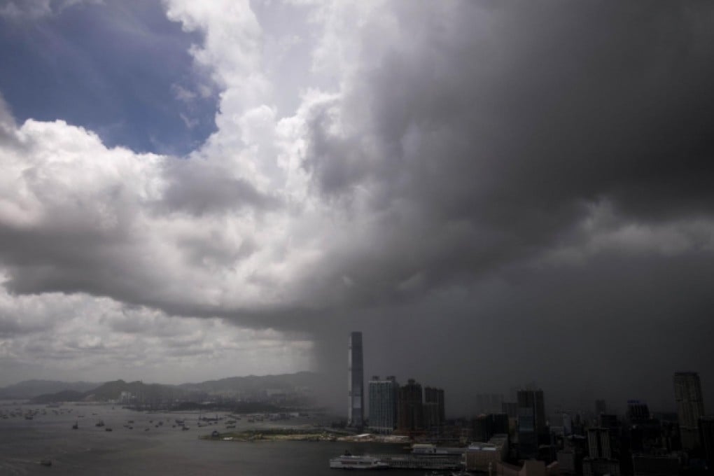 Clouds darken the sky above West Kowloon as tropical storm Rumbia brought rainfall and winds to the city. Photo: SCMP