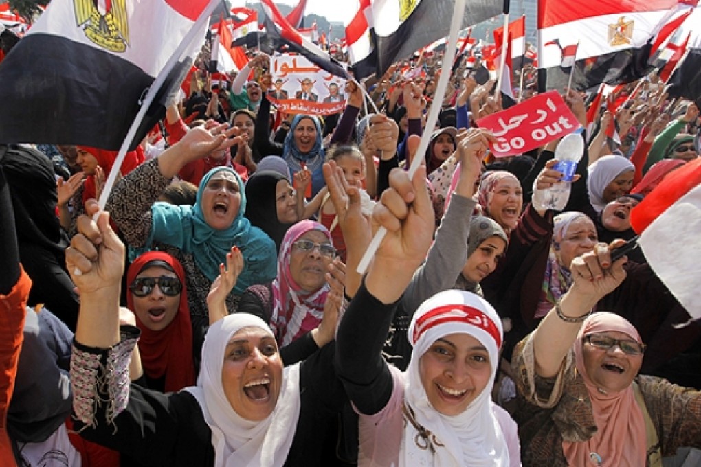 Egyptian women celebrate the military's 48-hour ultimatum for President Mohammed Mursi and opposition leaders to reach an agreement in Cairo. Photo: AP