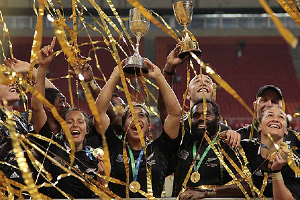 New Zealand's All Blacks teams celebrate with their both men and women's trophies after winning at the Rugby Sevens World Cup in Moscow. Photo: AP
