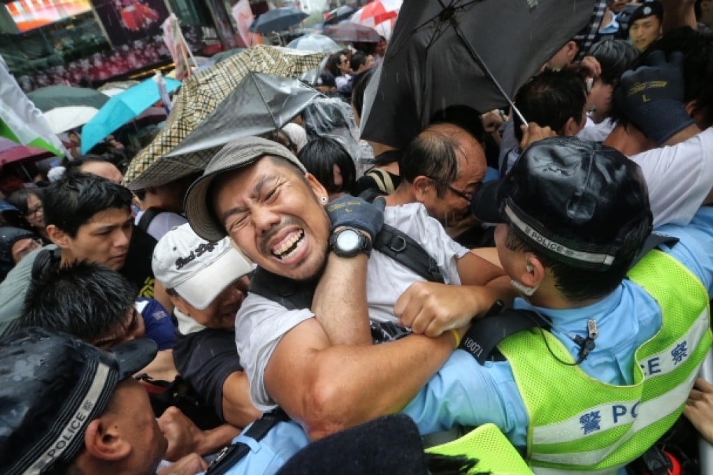 Protesters clash with police outside Sogo in Causeway Bay as officers tried to stop them joining the march there rather than in Victoria Park. Photo: Sam Tsang