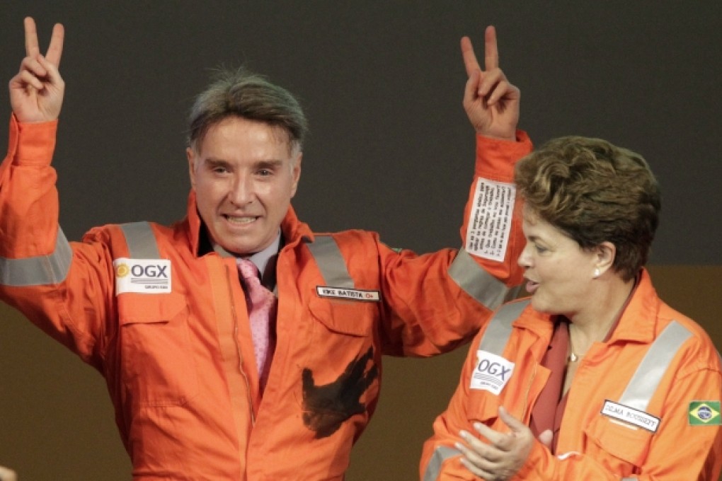 Brazilian billionaire Eike Batista (left), chief executive of EBX Group, gestures next to Brazil's President Dilma Rousseff during an April 2012 ceremony to mark the start of oil production of OGX. Photo: Reuters
