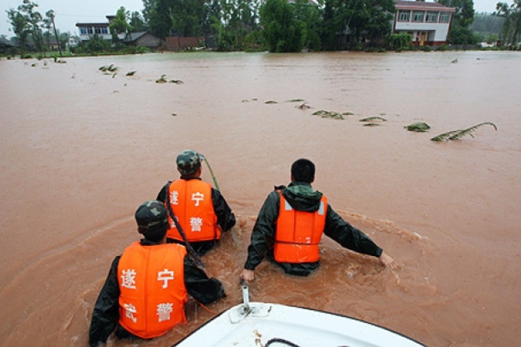 Rescuers head out to save trapped residents in a flooded area in Suining, southwest China's Sichuan province on Monday. Photo: AFP
