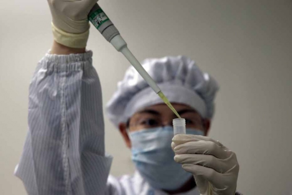 A lab technician tests for the H7N9 virus. Photo: EPA