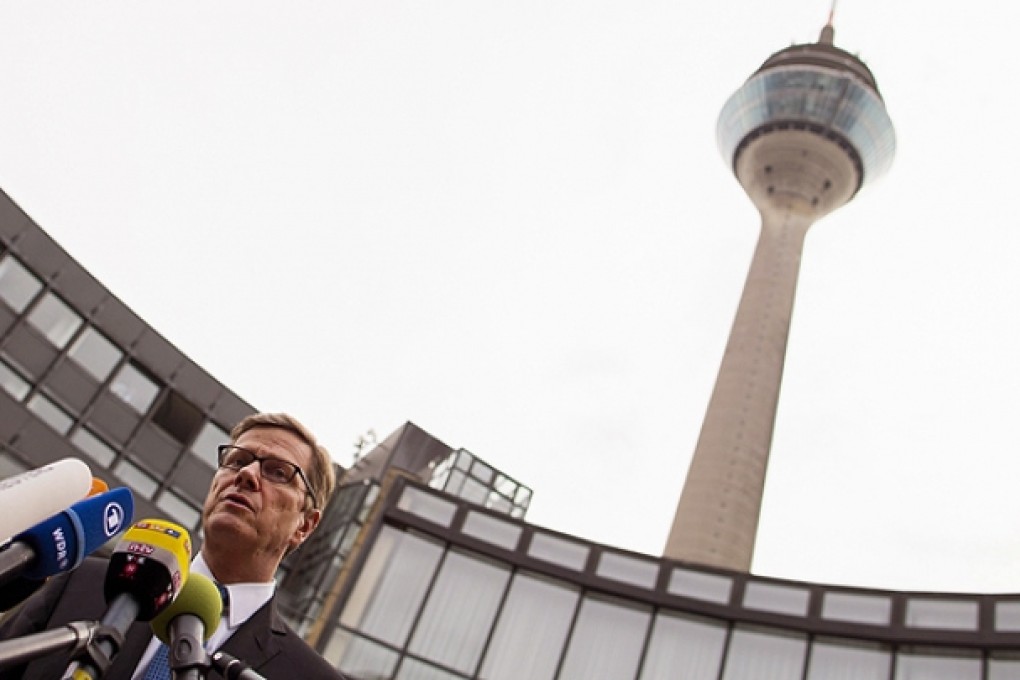German Foreign Minister Guido Westerwelle comments on the activities of the US National Security Service (NSA) in front of the state parliament in Dusseldorf. Photo: EPA