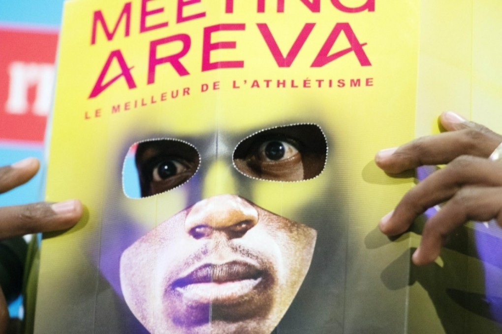 Usain Bolt poses with a cut-out mask in Paris. Photo: AFP