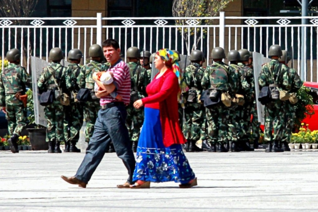 Pramilitary police patrol the People's Square in Urumqi, Xinjiang. Authorities have moved to quell unrest in the region. Photo: Simon Song