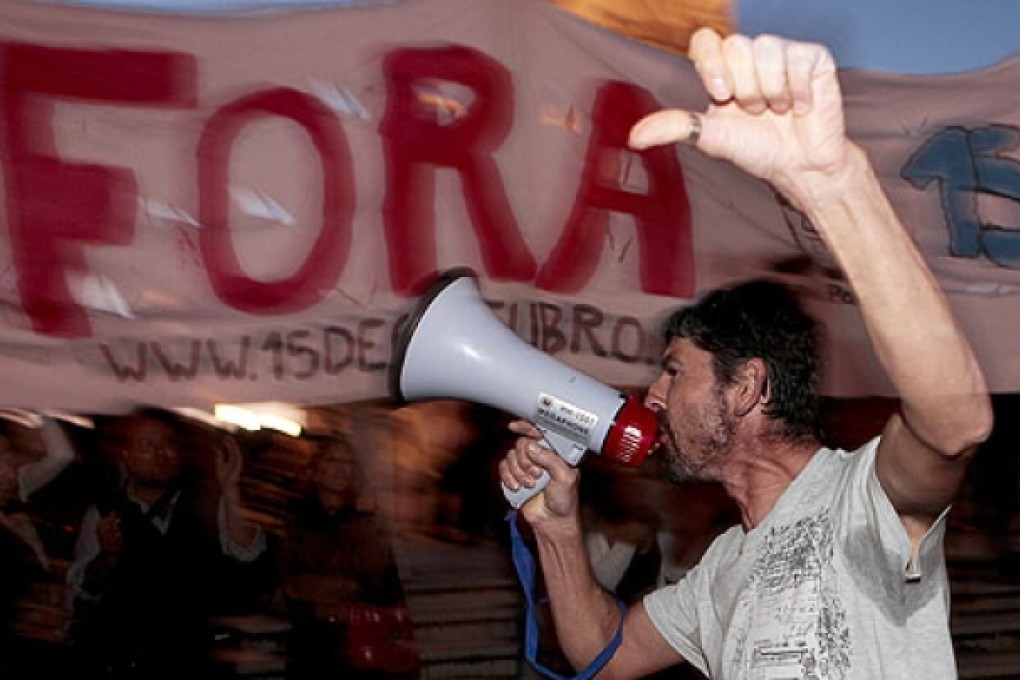 Demonstrators gather in a protest in central Lisbon to demand the resignation of the Portuguese government. Photo: EPA