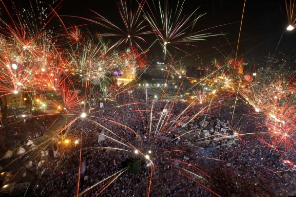 Fireworks light up the sky as opponents of Egypt's Islamist President Mohammed Mursi celebrate in Tahrir Square in Cairo, but pockets of supporters lament the leader's ousting. Photo: AP