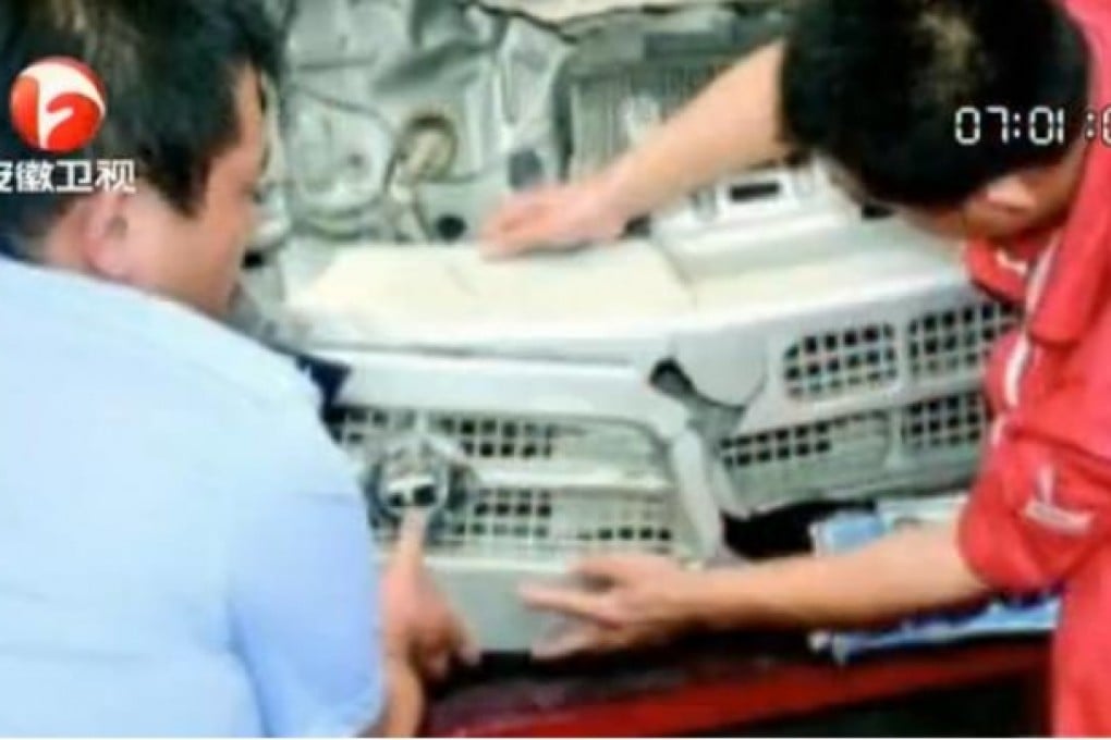 A screen grab from a news programme on Anhui Satellite TV shows police officers match wreckage fragments with Li's vehicle.