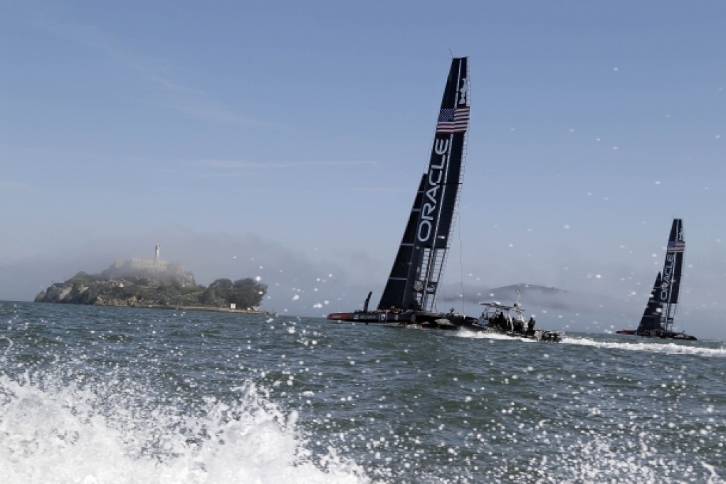 Oracle Team USA catamarans train near Alcatraz Island this week for the America’s Cup, which has drawn criticism from locals. Photo: AP