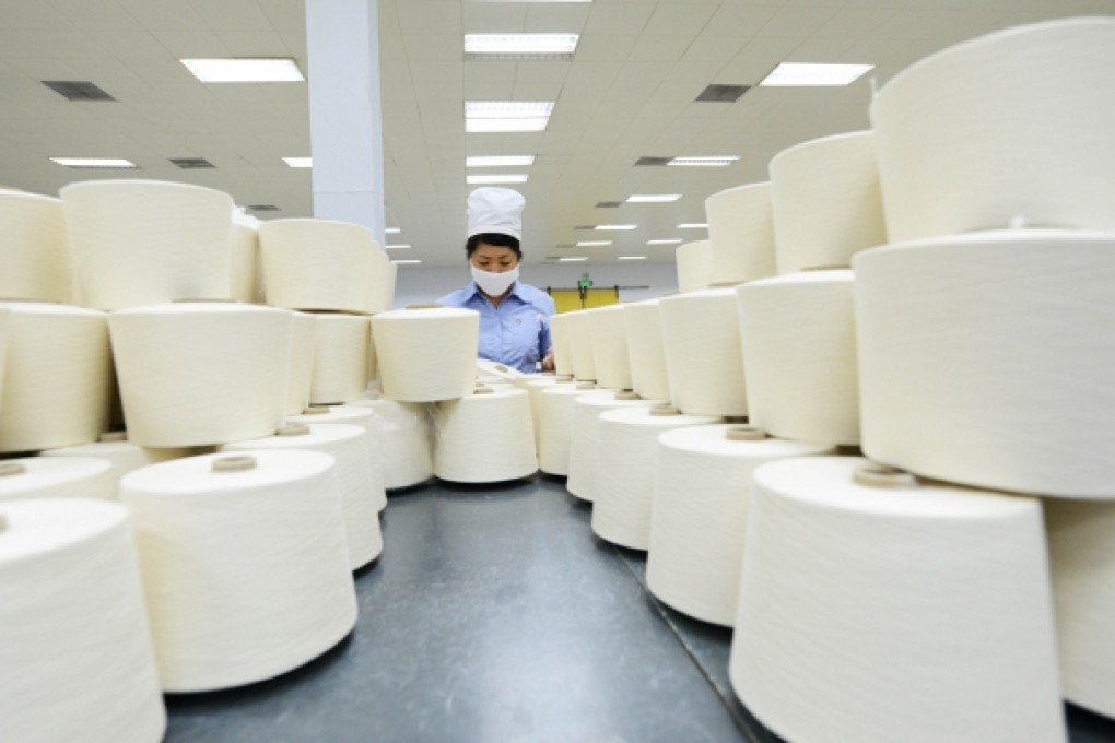 A worker works at a textile factory in Shandong. Photo: Xinhua