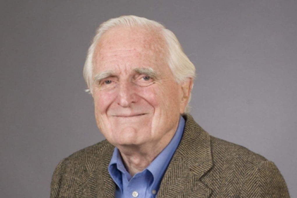 Engelbart with the first version of his mouse. Photo: EPA