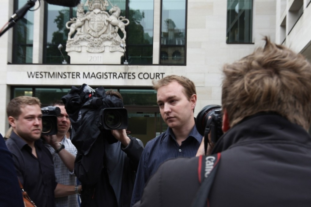 Tom Hayes, pictured here surrounded by media after a June court appearance, is the first suspect to come to court. Photo: AP