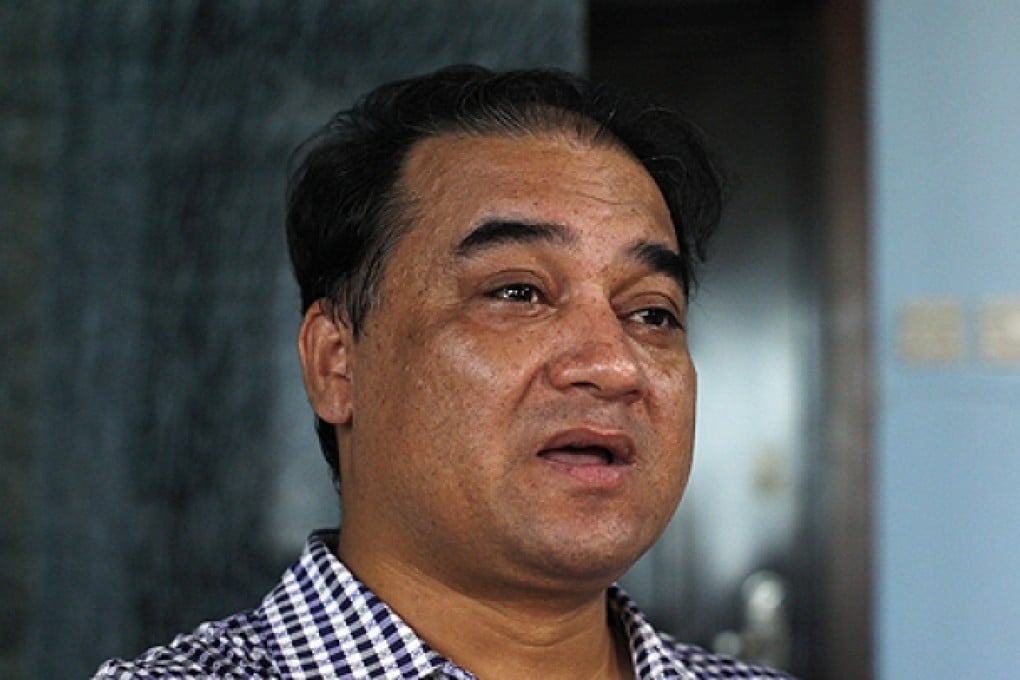 Outspoken Uygur scholar and advocate Ilham Tohti speaks during an interview at his home in Beijing on Friday. Photo: AP