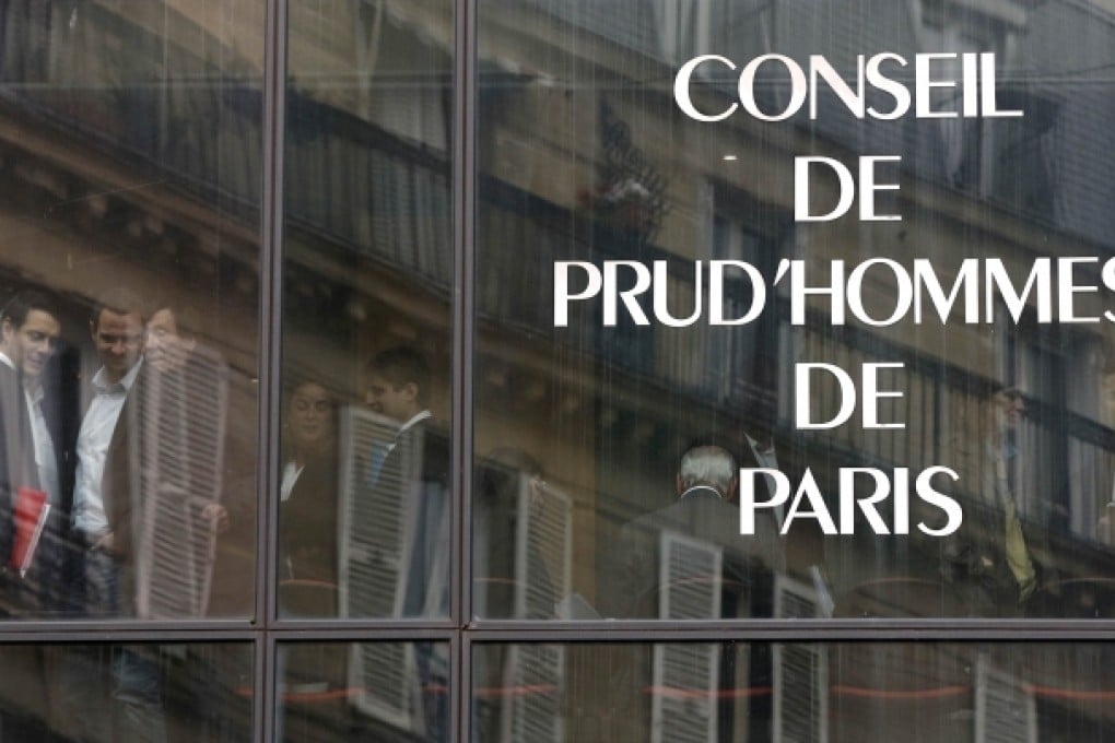 Jerome Kerviel (second left) and his lawyer David Koubbi (right) are reflected in a window as they arrive at court on Thursday. Photo: AFP