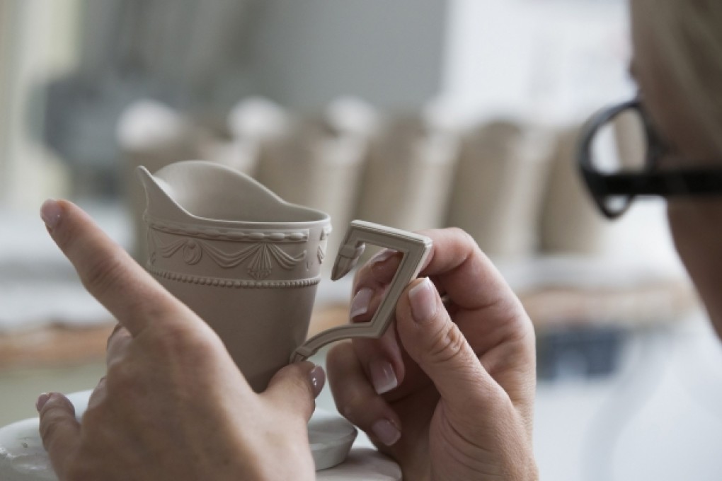 A worker attaches a handle to a jug at A Berlin-based porcelain maker. Despite a global slowdown, three out of four German Mittelstand firms are struggling to find skilled workers. Photo: Reuters