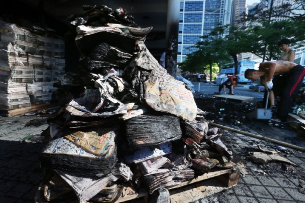 More than 20,000 copies of Apple Daily were burned by three masked men last month in Central. Photo: Sam Tsang