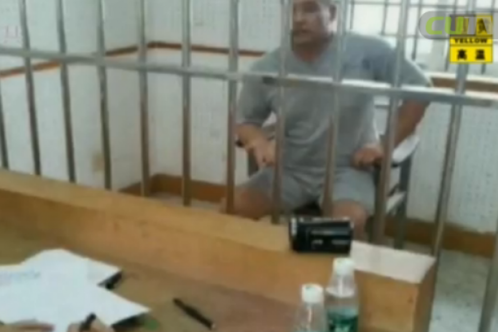 The man who was arrested in the fraud case is held, as shown in this screenshot from Shenzhen TV.