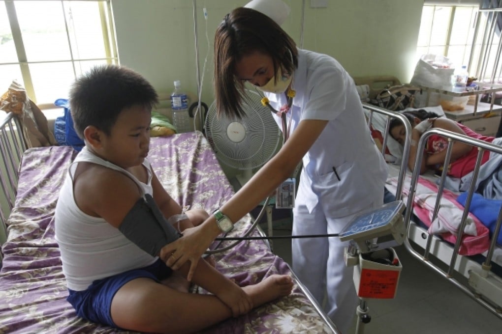 A boy is treated for dengue fever at a medical centre. Photo: EPA