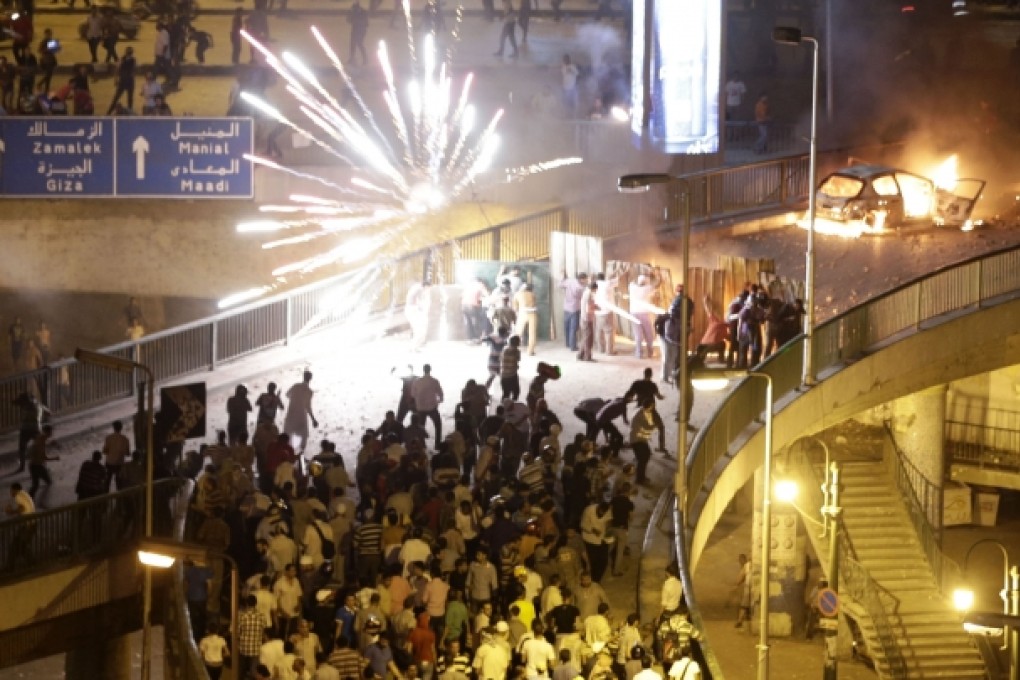 Supporters and opponents of Egypt's President Mohammed Mursi clash in Cairo. Photo: AP