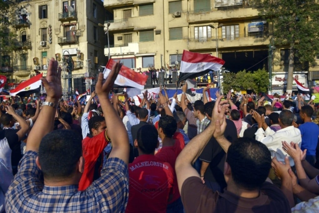 Egyptians celebrate at Tahrir square, one day after bloody clashes between supporters of ousted Egyptian President Mohammed Mursi and the opponents in Cairo. Photo: EPA