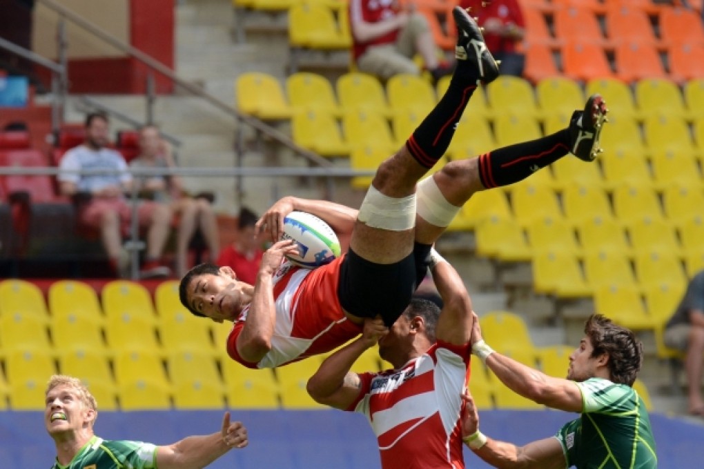 Players of South Africa and Japan fight for the ball during their group stage match in the Luzhniki Stadium. Taking the World Cup Sevens to Russia might have seemed like a good idea, but the near-empty stands showed otherwise. Photo: AFP