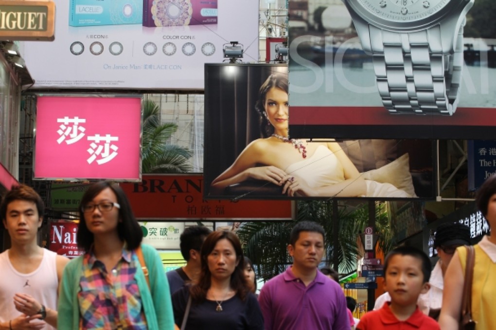 Pedestrians walk past stores on Russell Street in the Causeway Bay. Photo: Felix Wong