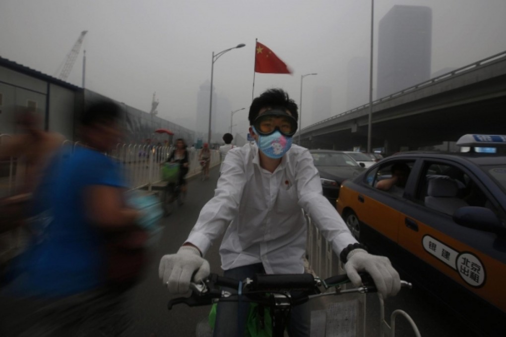 Another day, another challenging ride through Beijing's smog-engulfed streets. Photo: EPA