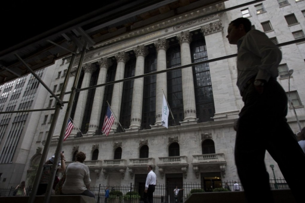 The bulls are gathering around the New York Stock Exchange, with analysts sharing the Federal Reserve's optimistic view. Photo: Bloomberg