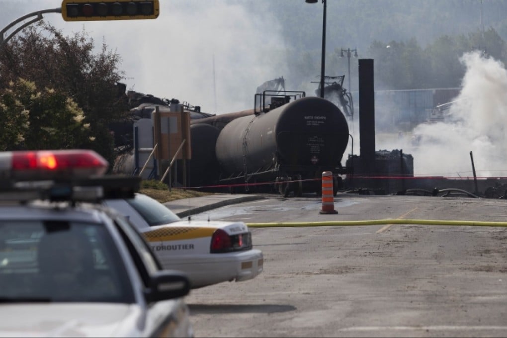 At least five people were killed, and another 40 are missing, after a train carrying crude oil rolled driverless down a hill into the heart of Lac-Megantic, Quebec, where it derailed and exploded, levelling the town centre. Photo: AFP