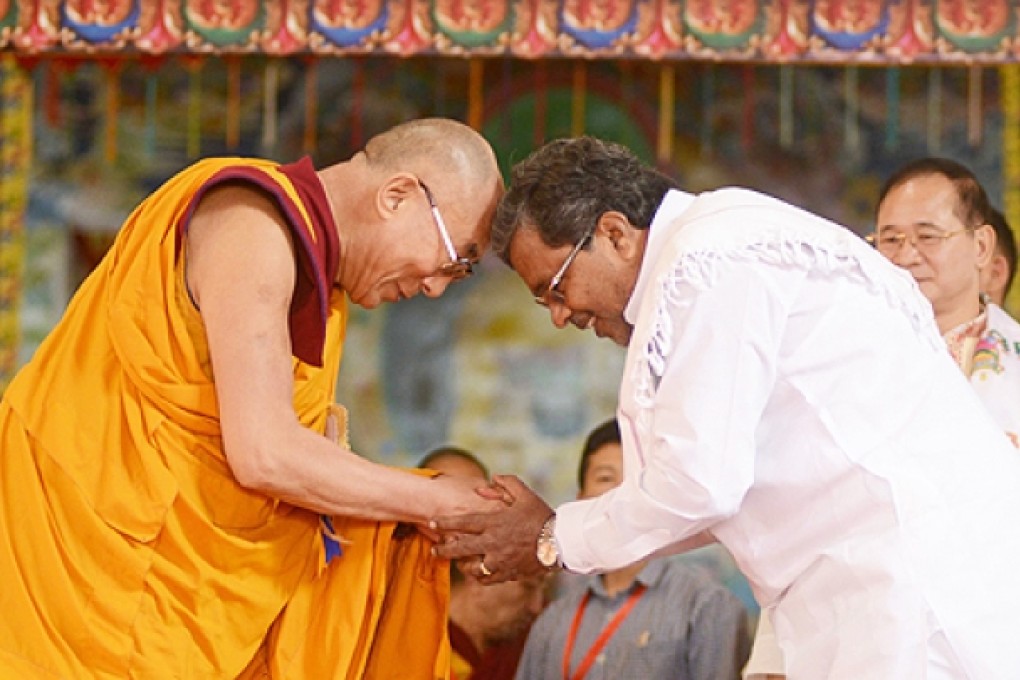 Tibetan spiritual leader The Dalai Lama (left) touch heads with India's Karnataka state Chief Minister Siddaramaiah during celebrations marking the Dalai Lama's 78th birthday in Bylakuppe on Saturday. Photo: AFP