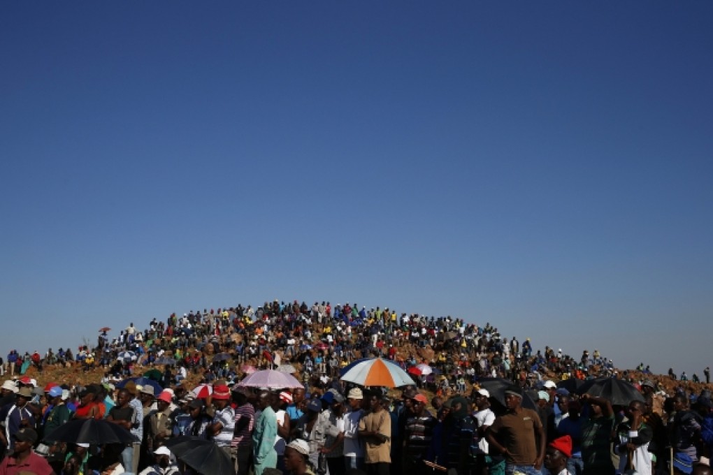 Striking gold miners evicted from company housing at a gold mine occupy a hill in this October 2012 protest. Photo: Reuters