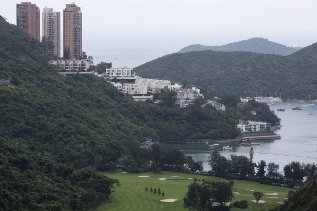 Residential buildings look over the Hong Kong Golf Club golf course, foreground, in the Deep Water Bay area. Photo: Bloomberg