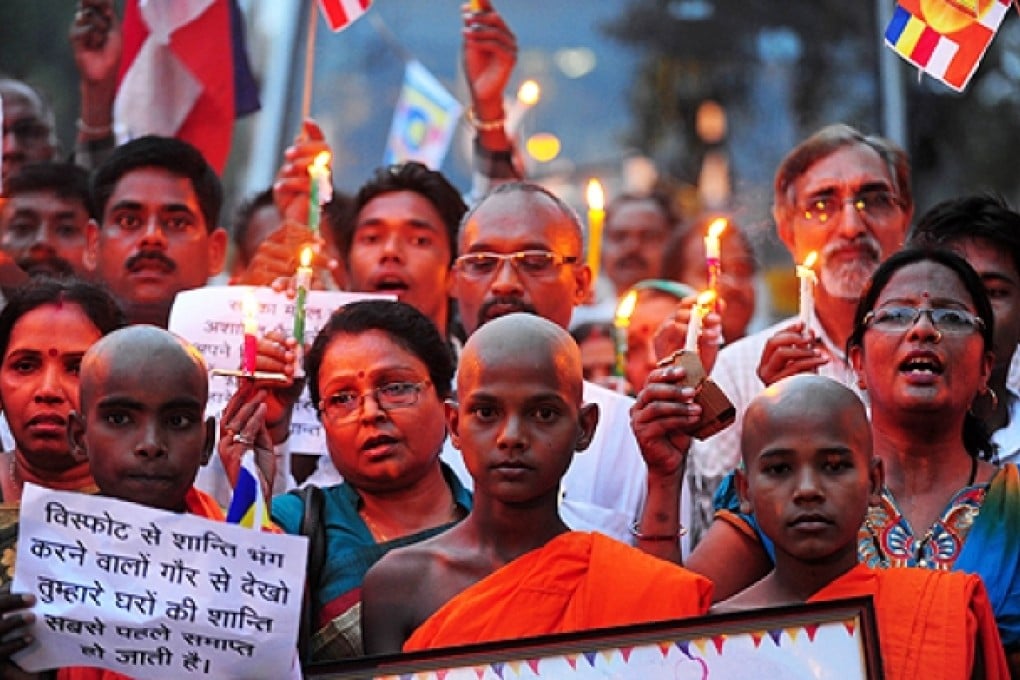 Members of the Bauddh Commune International participate in a peace vigil in Allahabad on Sunday, following a series of blasts at the Both Gaya temple. Photo: AFP