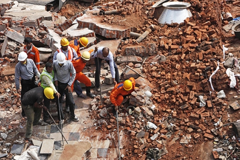 Indian rescue workers look for survivors from the debris of a collapsed building, in Hyderabad, India, on Monday. Photo: AFP
