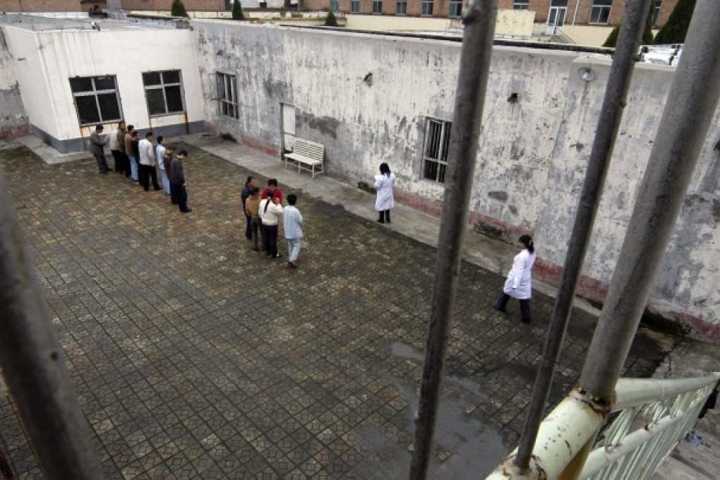 Patients stand at a yard inside a mental health hospital in China. Photo: Reuters
